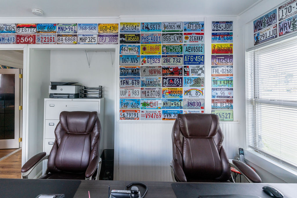Hilson Ink office wall lined with custom license plate graphics — About